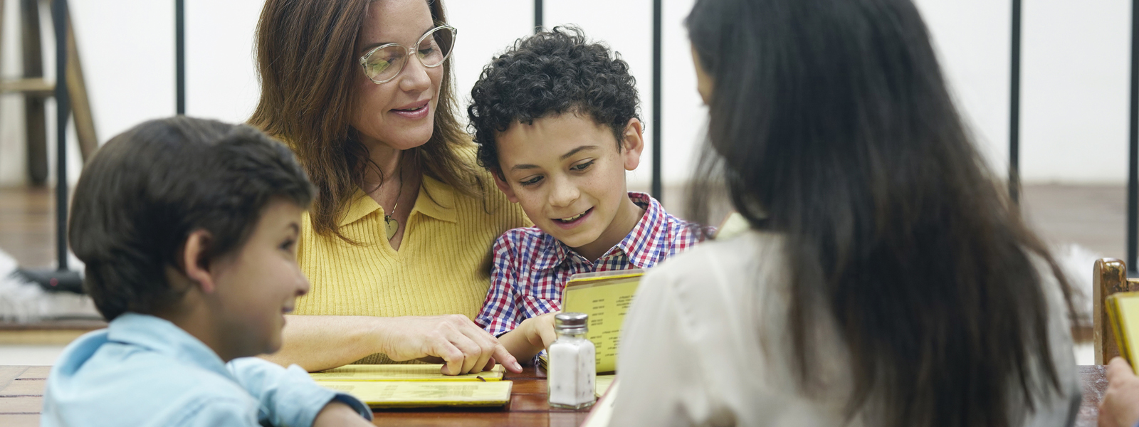 parents and children smiling and meeting with recruiter in school cafeteria